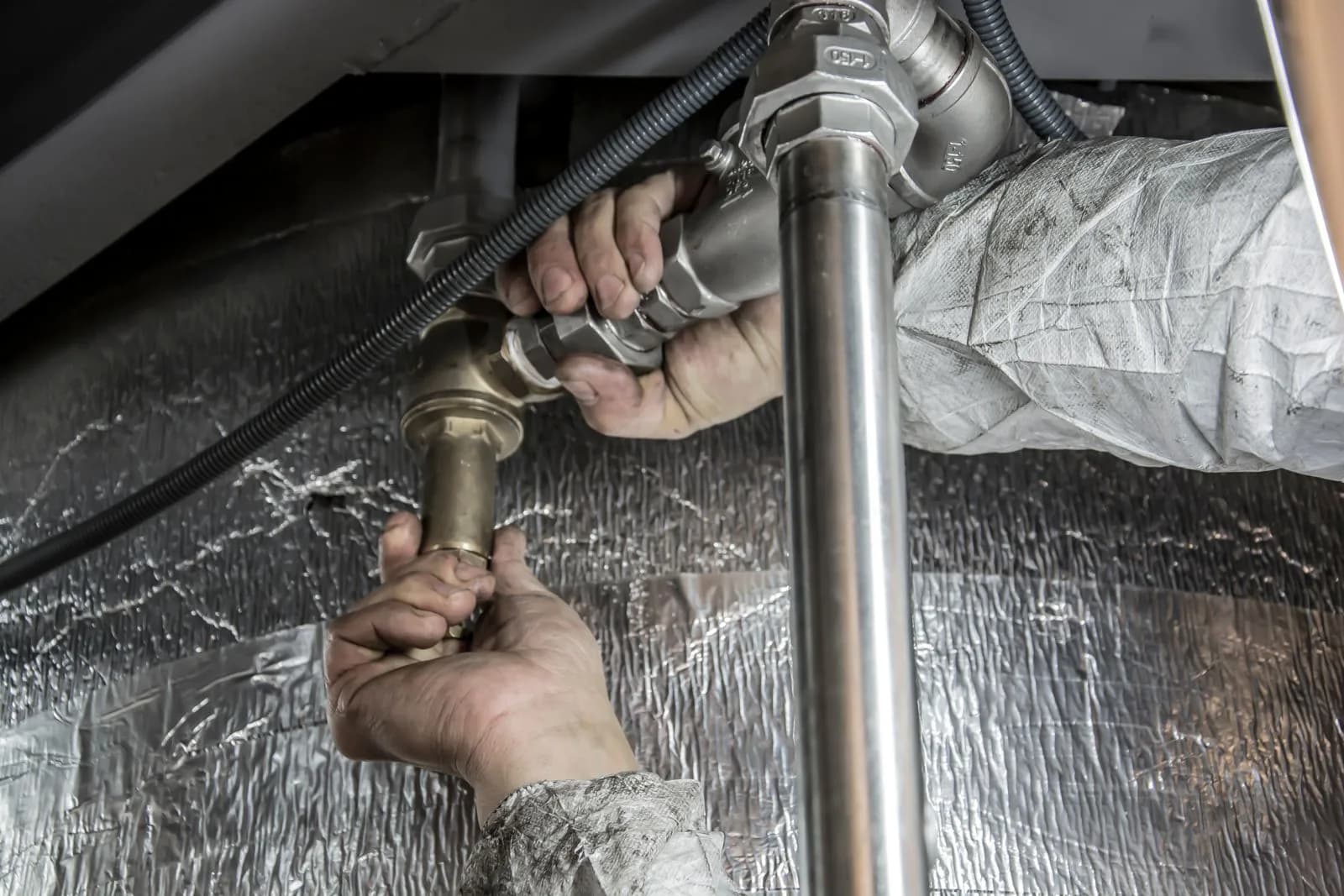 Plumber installing pipes — Plumbers marketing by TML Agency