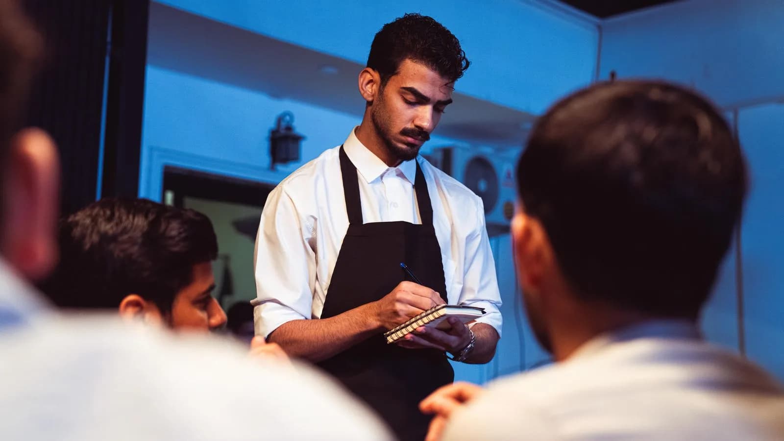 Restaurant host welcoming guests — Hospitality & Restaurants marketing by TML Agency