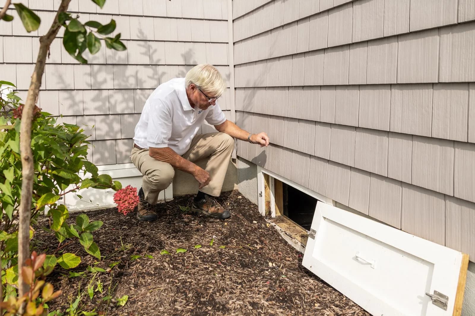 Pest technician inspecting home — Pest Control Companies marketing by TML Agency